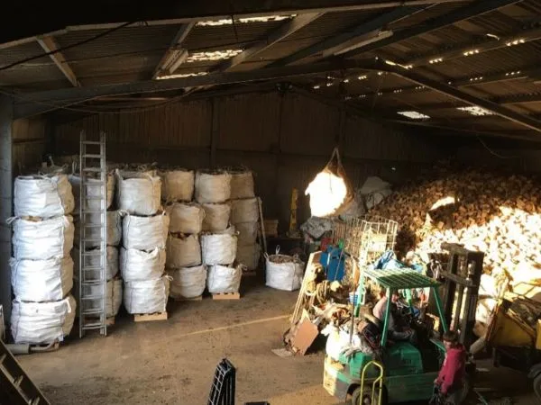 Logs U Like - Firewood Supplier Harefield Yard Jumbo bags of firewood stacked inside the Logs U Like storage unit in Harefield.
